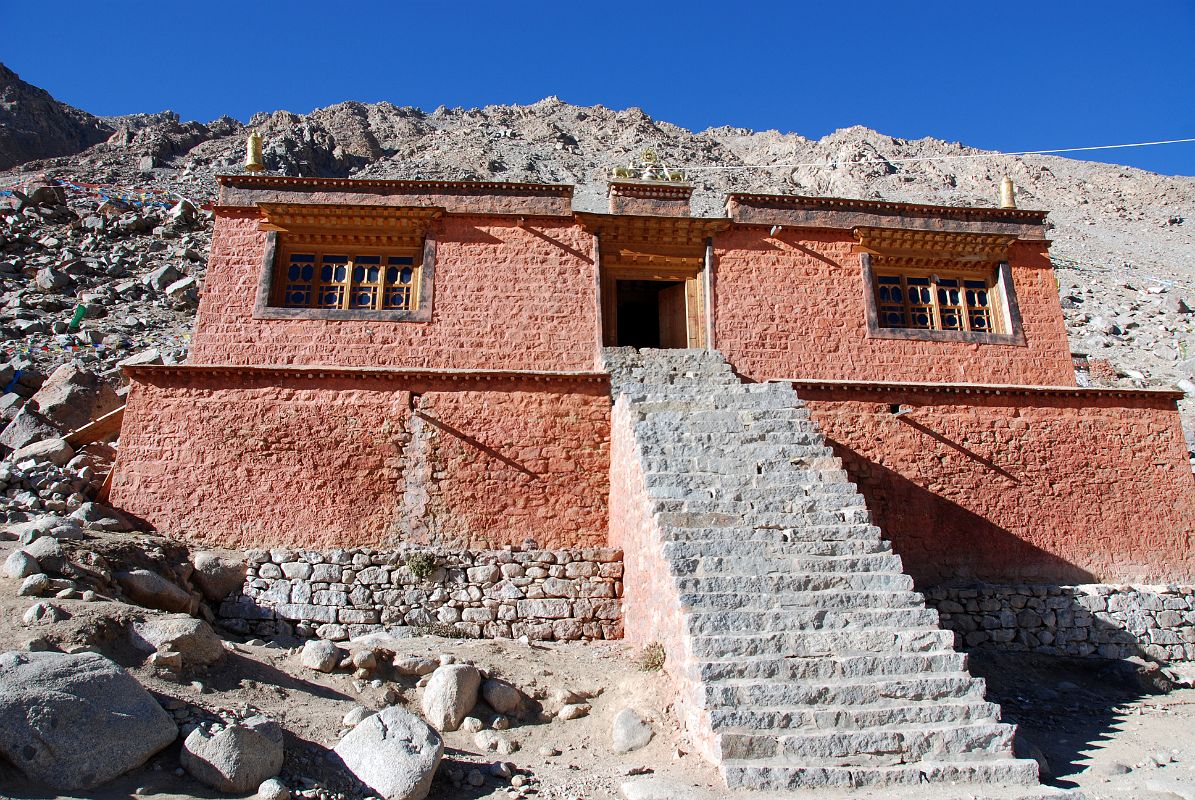 31 Dirapuk Gompa Entrance Steps On Mount Kailash Outer Kora A series of steps lead to the entrance to Dirapuk Gompa (5074m). Dirapuk takes its name from the words dira meaning female-yak-horn and puk meaning cave. The great monk Gotsangpa meditated her, supposedly from 1213 to 1217, and Buddhists say he first discovered the kora route around Kailash. He was led to Dirapuk by a yak that turned out to be the lion-faced-goddess Dakini (Tib, Khandroma), who guards the Khando Sanglam La.
